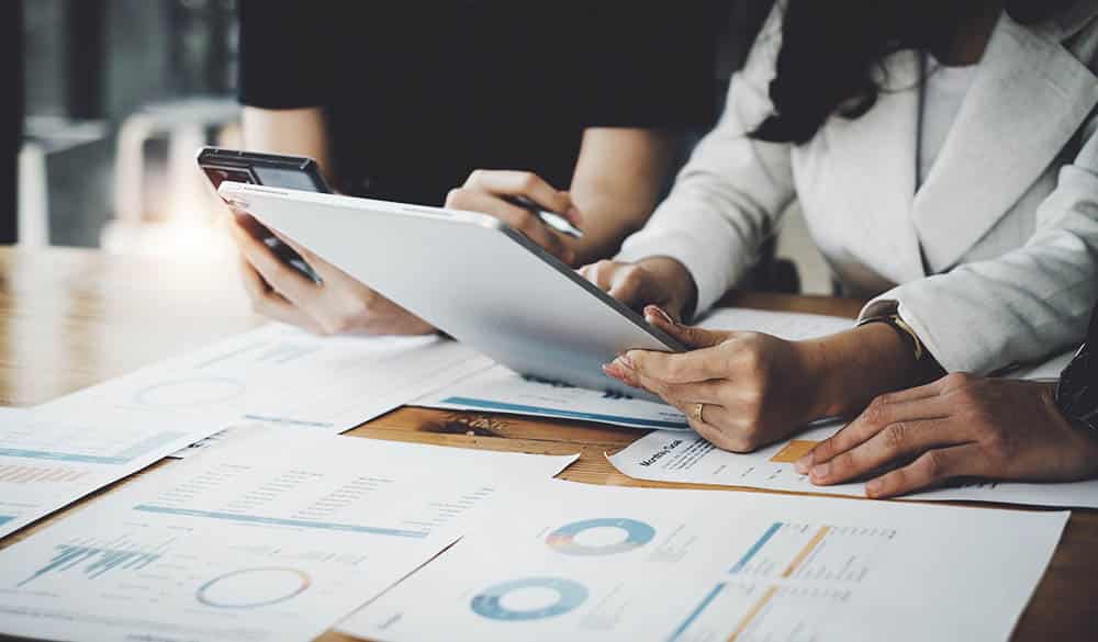 Image of Audit team working together and looking at a transaction for a company.