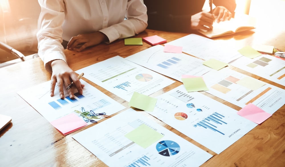 Reviewing documents and charts to develop a business valuation proposal