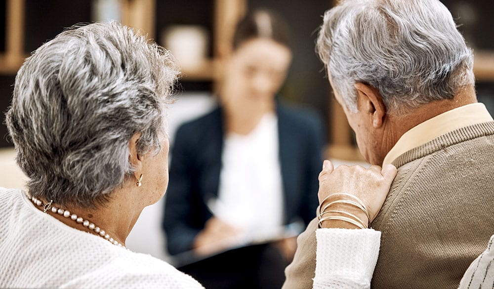 Elderly couple getting set up with financial services